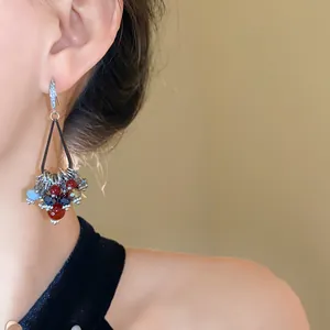 Detail view of bohemian retro earrings with multicolored glass beads and zircons