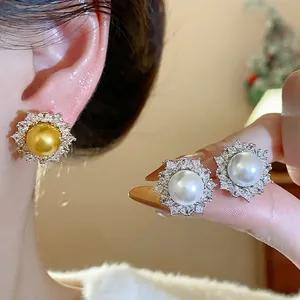 Elegant French style silver needle pearl earrings with sparkling zircon sunburst design.