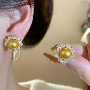 Elegant gold pearl and zircon sunflower stud earrings featuring a high-end French design