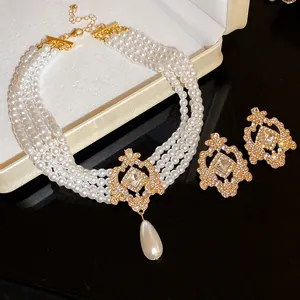 Detailed macro shot of multi-strand pearl necklace with ornate gold rhinestone pendant