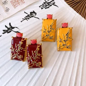 Close-up of New Chinese style rectangular earrings in red and yellow with plum blossom motif