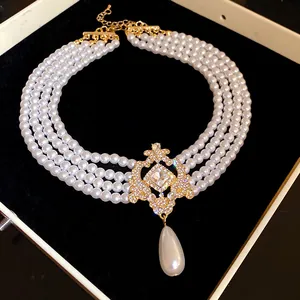 Detail view of luxury French court style multi-strand pearl choker with crystal pendant