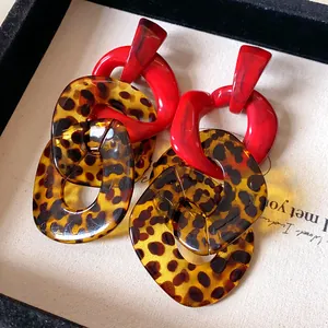 Detailed shot of vintage leopard print and red acrylic resin chain drop earrings