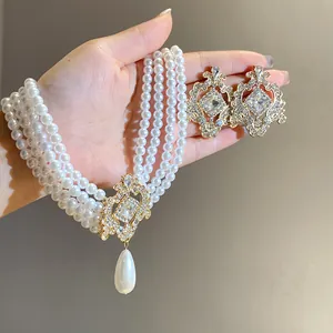 Close-up detail of luxury vintage rhinestone earrings and multi-strand pearl necklace set