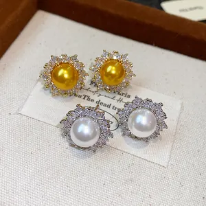 Detailed close-up of French-style pearl stud earrings with shimmering zircon sunflower halos.