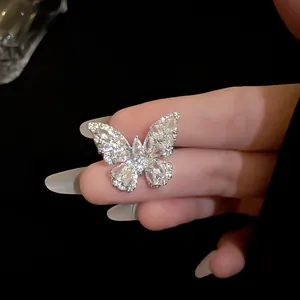 Macro detail of a sparkling zircon butterfly ring featuring elegant marquise cut stones.