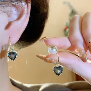 Detailed close-up of French vintage heart-shaped crystal earrings with elegant pearl accents