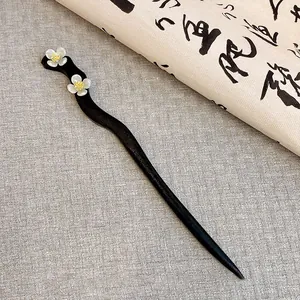 Elegant traditional Chinese wooden hairpin with delicate white flower charms for Hanfu.