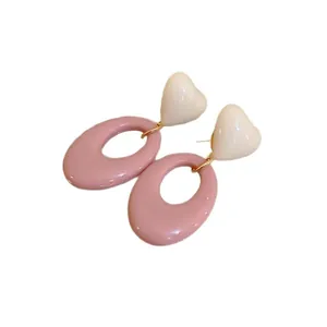 French style heart and pink oval drop earrings with gold accents on white background