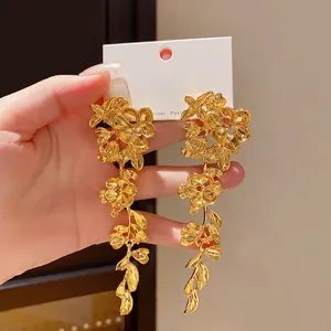 Eleganti orecchini lunghi a nappina con fiori e foglie dorati in audace stile heavy metal