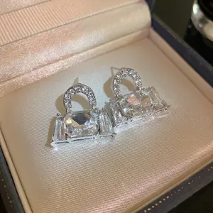 Elegant silver needle bag-shaped stud earrings featuring sparkling crystal diamonds