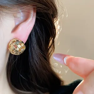 Vista macro dettagliata di orecchini a clip intrecciati placcati in oro 18 carati