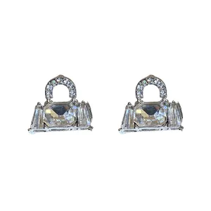 Elegant silver bag-shaped stud earrings featuring clear sparkling crystal accents.