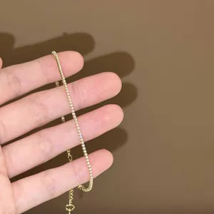 Gros plan détaillé d'un bracelet de tennis doré minimaliste avec zircons clairs