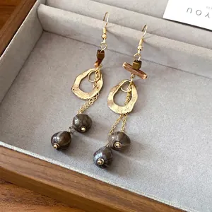 Handcrafted retro ethnic earrings with irregular hollow gold hoops and wood beads