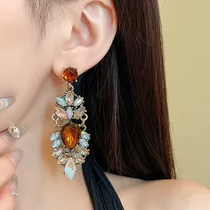 Vue détaillée de boucles d'oreilles pendantes style palais avec cristaux ambrés