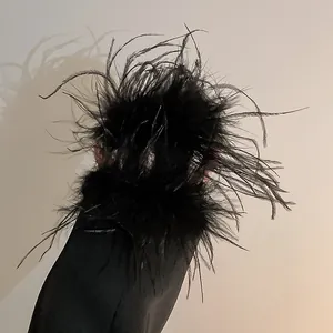 Detailed view of a luxury black ostrich feather hair claw clip with fluffy texture