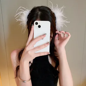 Elegant white ostrich feather hair claw clips worn by a model for a chic hair style