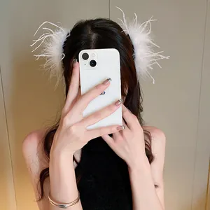 Close-up of elegant white ostrich feather hair clip worn by a model in a lifestyle setting