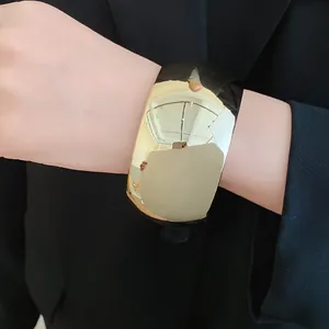 Detail view of bold wide gold acrylic cuff bracelet featuring a high-gloss mirror finish