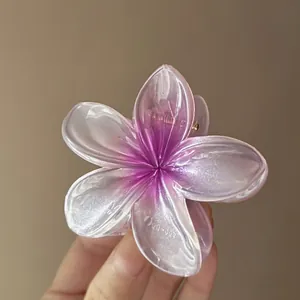 Detailed view of translucent gradient purple flower hair claw clip with glitter finish