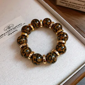 Detailed view of leopard print acrylic beads and gold spacers on a luxury bracelet