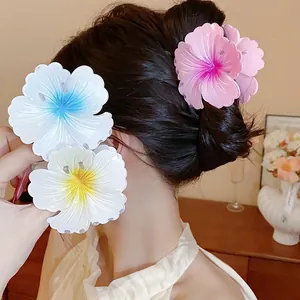 Large colorful flower hair claw clips with textured petals for thick hair styling.
