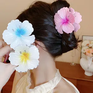 Detailed view of large pleated flower hair claw clips with vibrant gradient colors