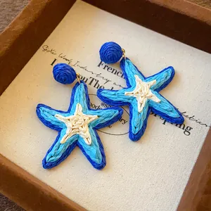 Hand-woven blue and white starfish drop earrings perfect for summer beach resort style