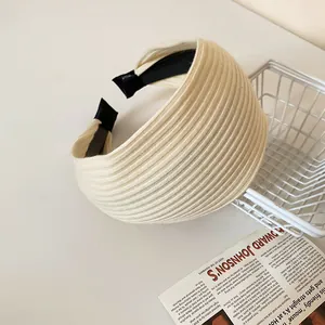 Detail of cream wide ribbed headband with anti-slip lining for elegant hair styling