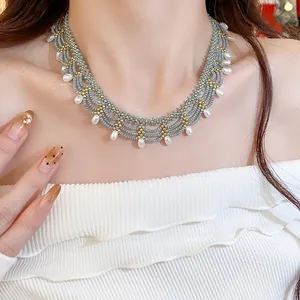 Detail view of multi-layered beaded lace necklace with gray beads and white pearls