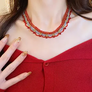 Detail view of ethnic style red and silver glass beaded lace necklace on model
