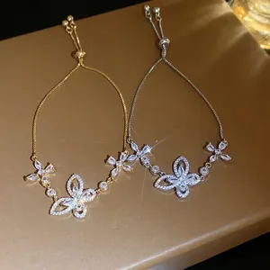 Close-up of elegant butterfly bracelets with sparkling zircon in gold and silver