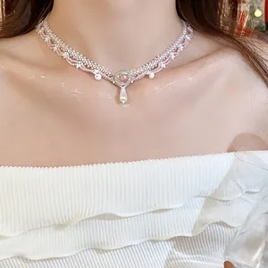 Detail view of pink and white glass beaded lace necklace with a teardrop pearl pendant