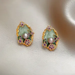 French vintage oval flower stud earrings with enamel and pearl accents.