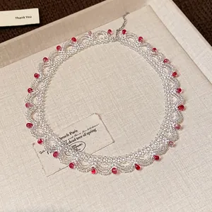 Close-up of a handmade glass bead lace choker necklace with elegant red accents