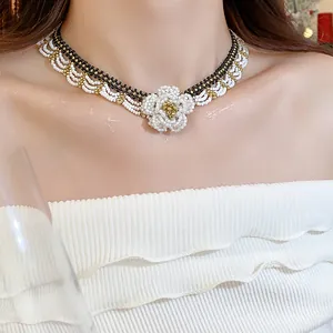 Close-up detail of a handmade beaded flower choker necklace with elegant glass beads.