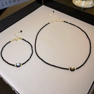 Detailed view of elegant gold plated black crystal cat head necklace and bracelet set