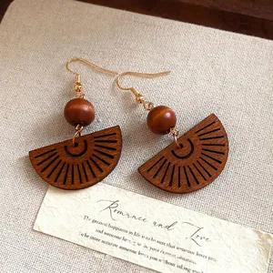 Handmade Bohemian wood bead hollow fan drop earrings with a vintage ethnic style