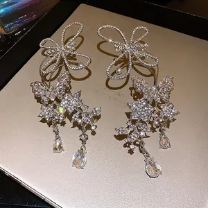 Elegant silver-finish rhinestone butterfly ear cuffs with crystal water drop tassels.