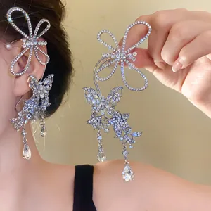 Detailed view of luxury rhinestone butterfly ear cuffs with dangling crystal drops