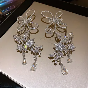 Elegant close-up of rhinestone butterfly ear cuff with dangling teardrop crystals