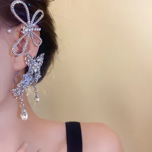 Close-up of elegant rhinestone butterfly ear cuff with teardrop crystal pendants