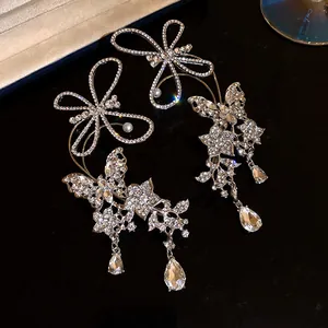 Macro view of luxurious rhinestone butterfly ear cuffs with sparkling crystal teardrop drops