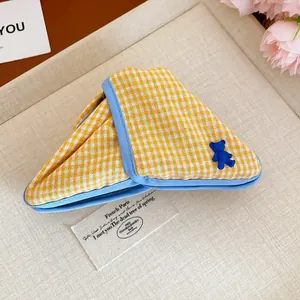 Triangular yellow plaid fabric hair claw clip with a cute blue bear charm detail