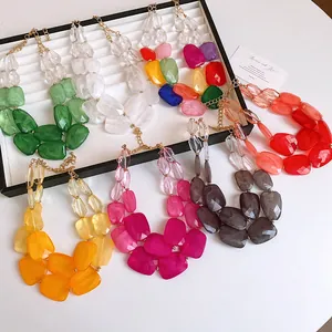 Multiple colors of irregular acrylic beaded double-layer necklaces on a jewelry display tray