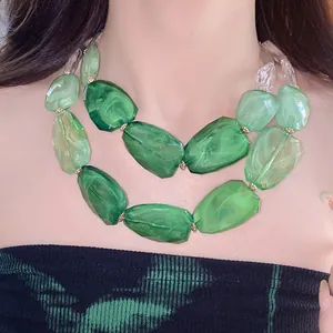 Detail view of chunky green irregular acrylic beads in a double-layered necklace