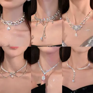 Close-up details of French style rhinestone necklaces with waterdrop pendants on neck