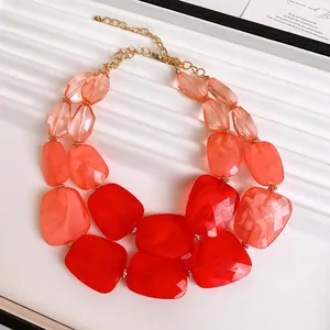 Detail shot of double-layer necklace with irregular vibrant red and orange acrylic beads