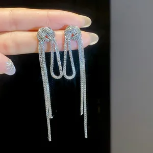 Silver knotted tassel earrings with long mesh chains for an elegant retro style